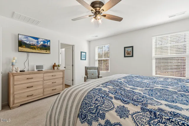 a spacious bedroom with a bed and a couch