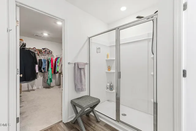 a spacious bathroom with a shower sink and mirror