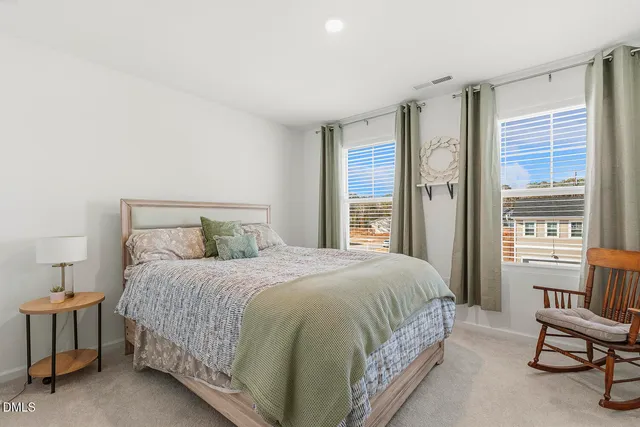 a view of a hallway and a dining room with furniture