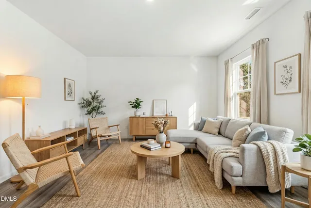 a living room with furniture and wooden floor