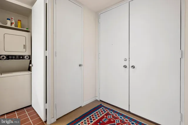 a living room with furniture a rug and a wall painting