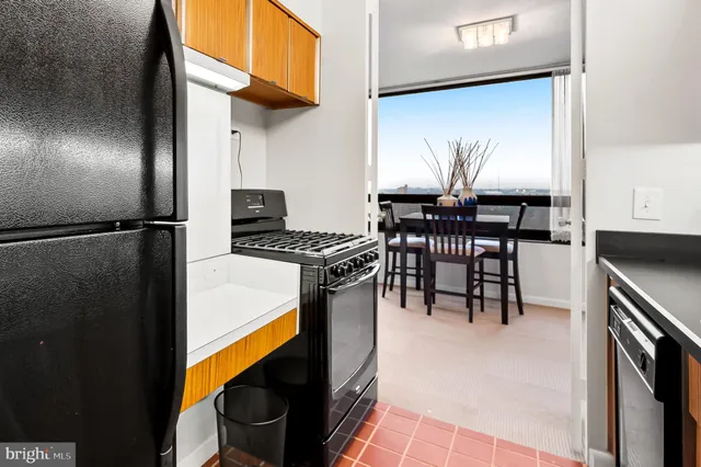 a kitchen with stainless steel appliances a sink dishwasher and cabinets with wooden floor