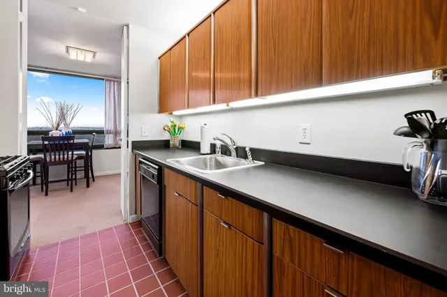 a kitchen with stainless steel appliances a stove a sink and a microwave