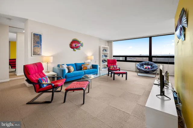 a living room with furniture gym equipment and a window