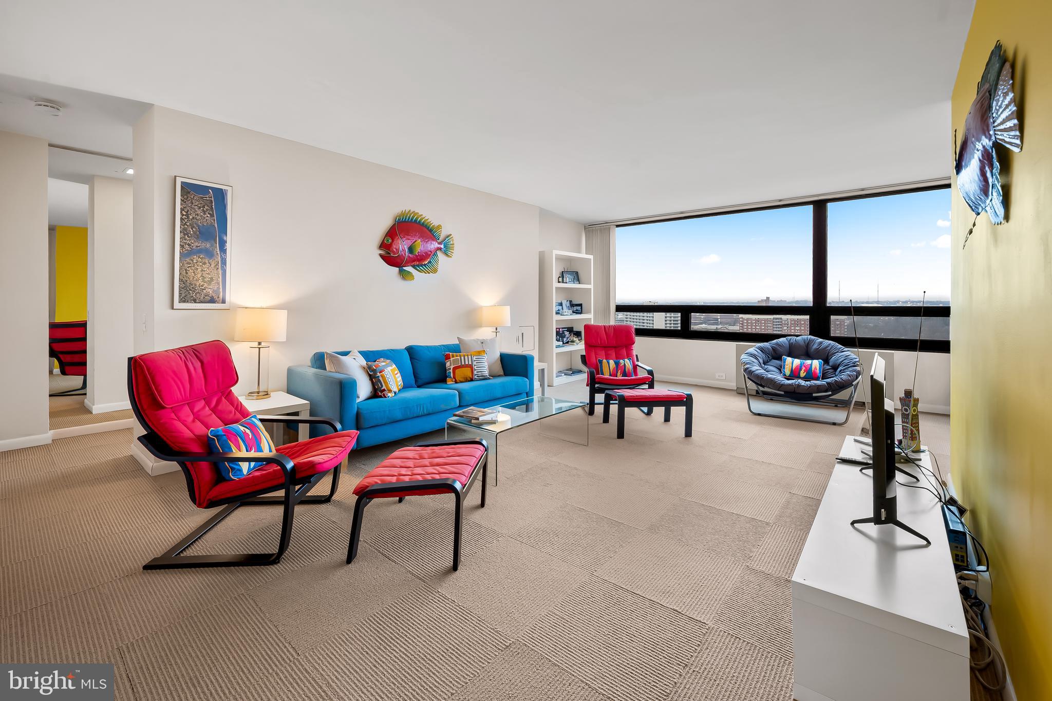 4000 North Charles Street, Unit 1605 Baltimore, MD 21218 - Photo 2 of 45 a living room with furniture gym equipment and a window