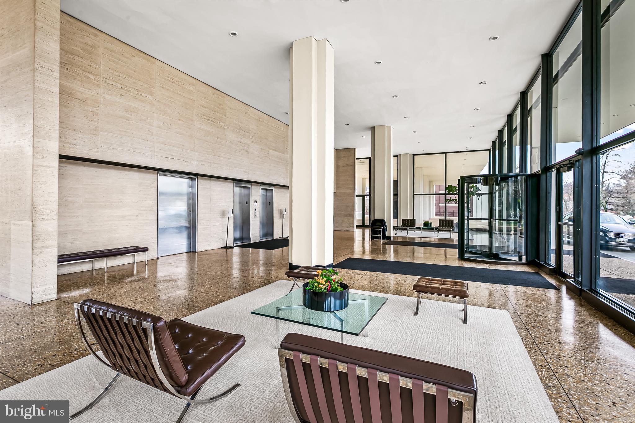 4000 North Charles Street, Unit 1605 Baltimore, MD 21218 - Photo 33 of 45 a living room with furniture and floor to ceiling windows