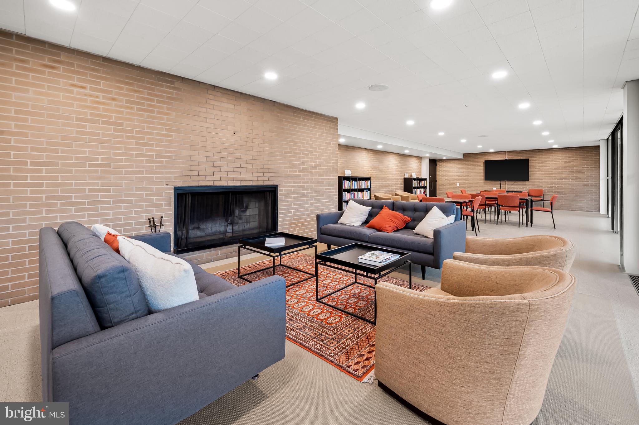 4000 North Charles Street, Unit 1605 Baltimore, MD 21218 - Photo 38 of 45 a living room with furniture and a fireplace