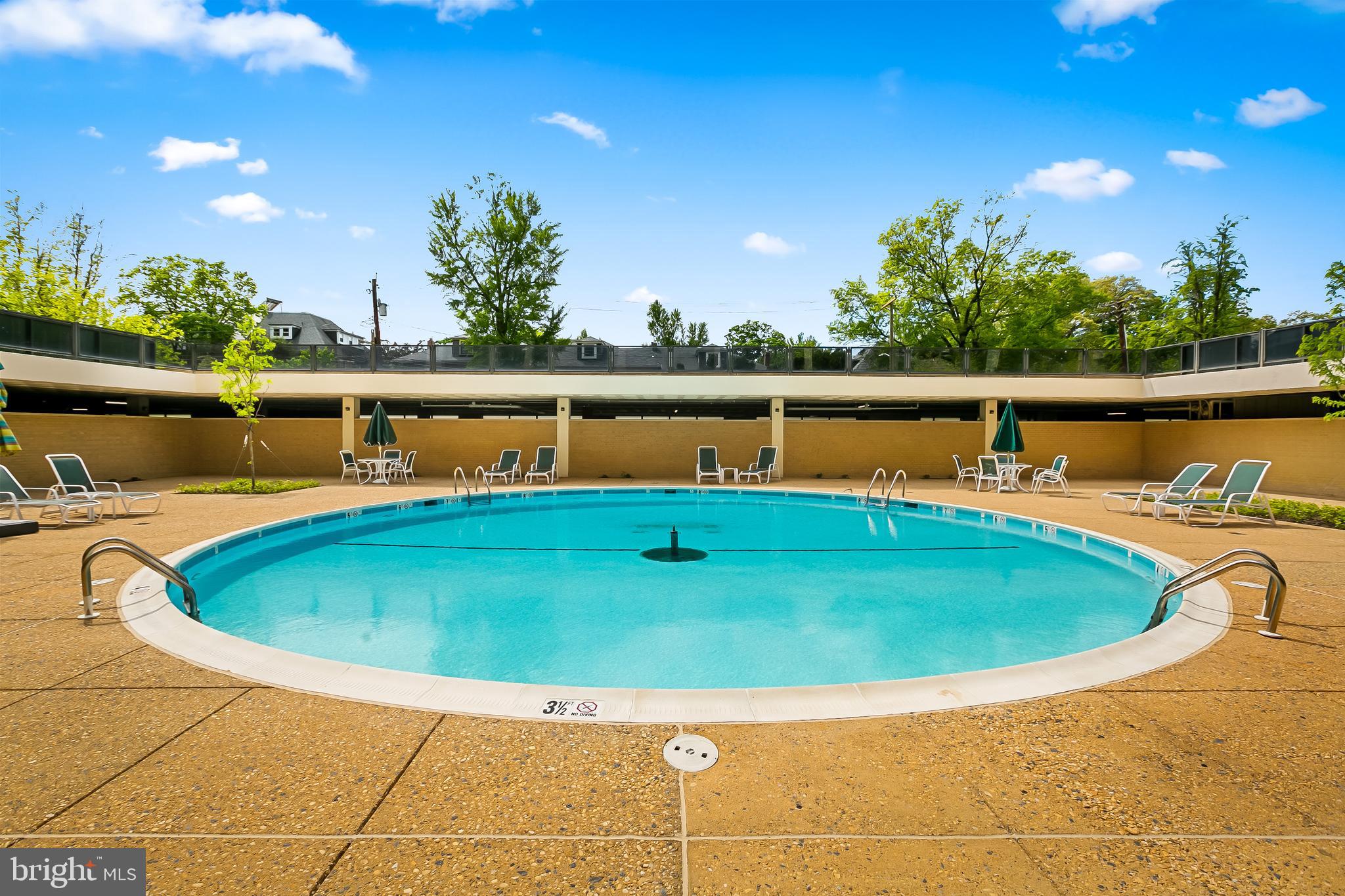 4000 North Charles Street, Unit 1605 Baltimore, MD 21218 - Photo 42 of 45 a view of a swimming pool with a yard