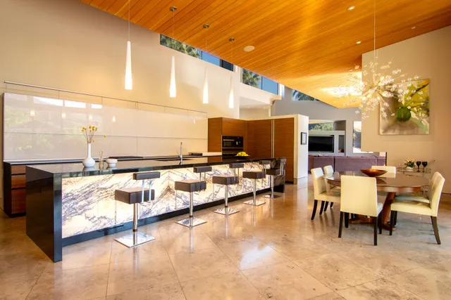 a large bed sitting in a bedroom next to a window