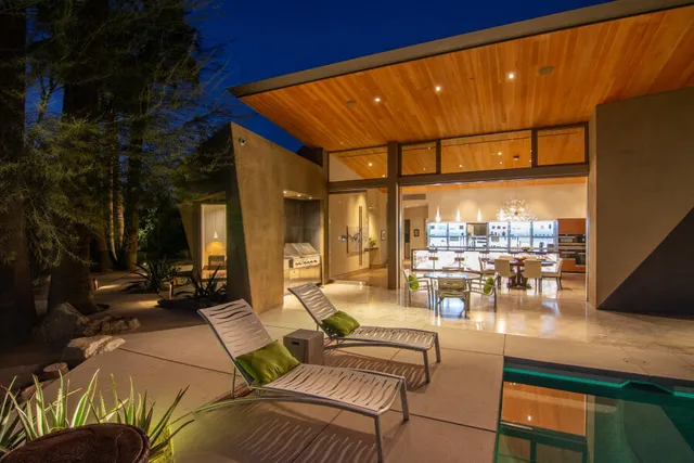 a view of a house with swimming pool and sitting area