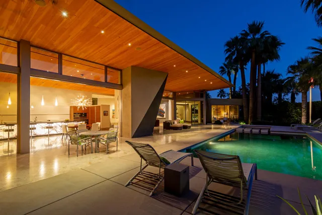 a view of a patio with swimming pool table and chairs