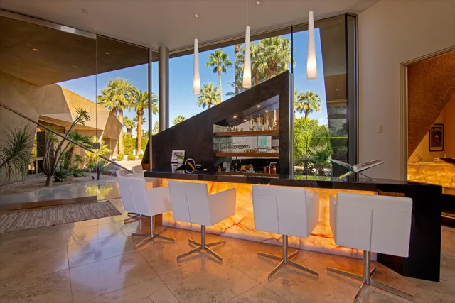 a view of a dining room with furniture a chandelier and a large window