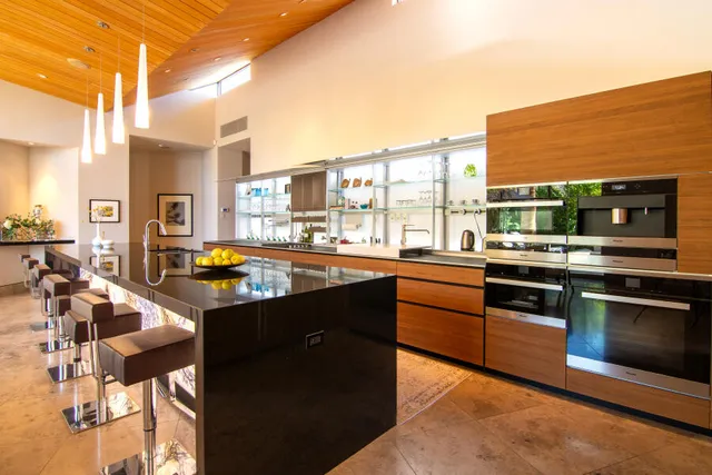a dining room with furniture and a kitchen view