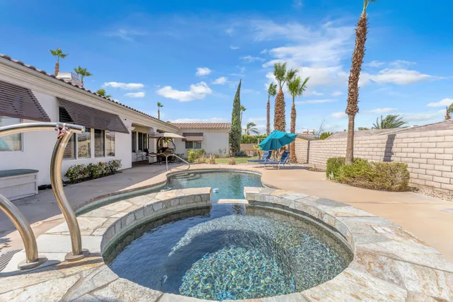 a view of a swimming pool with outdoor seating