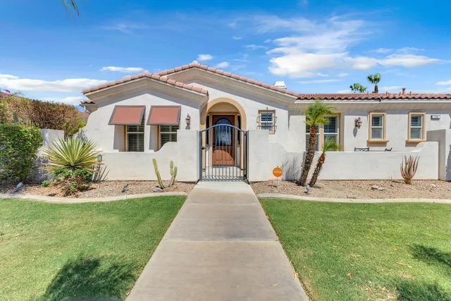 a front view of a house with a yard and entertaining space