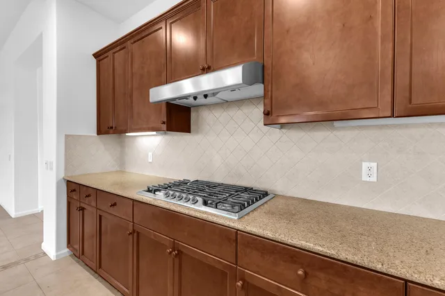 a kitchen with stainless steel appliances granite countertop a sink stove and cabinets