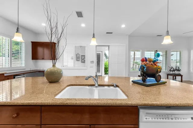a kitchen with a sink a counter and cabinets