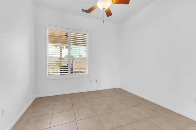 an empty room with windows and cabinet