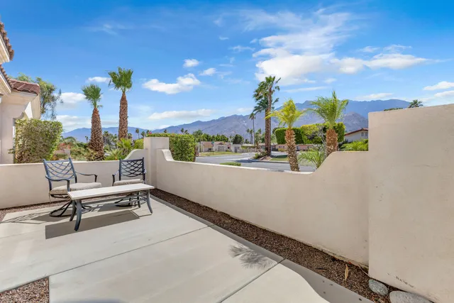 a view of a patio with a table and chairs