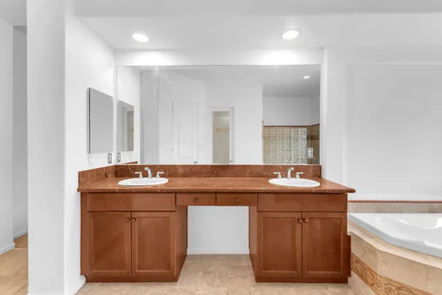 a spacious bathroom with a tub and a sink