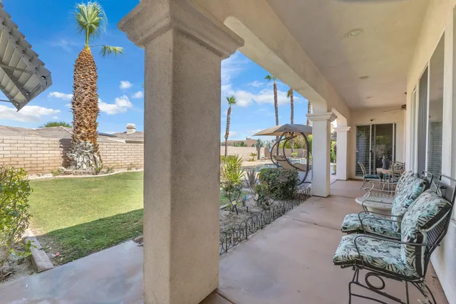 a view of a porch with furniture and garden