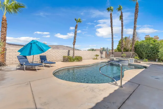 a view of a swimming pool with chairs