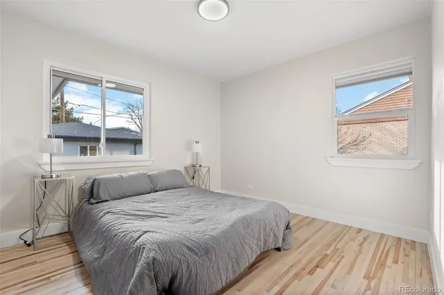 a bedroom with a bed and wooden floor