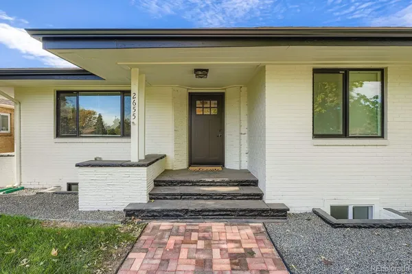 a front view of a house with a rug