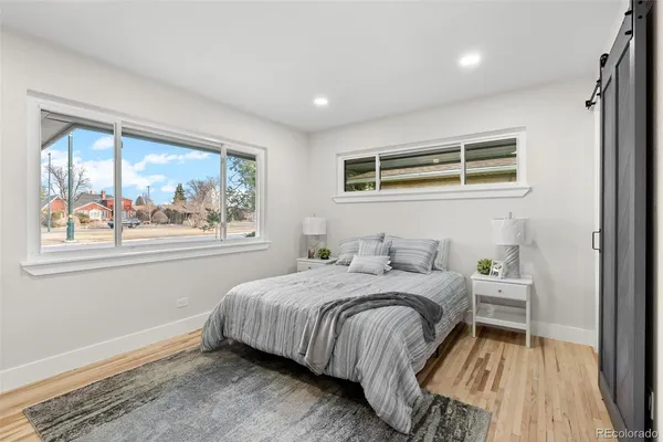 a bedroom with a bed and a large window