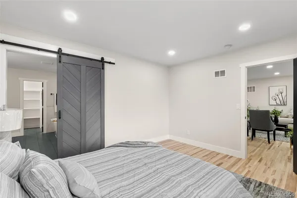 a bedroom with a bed and a chair