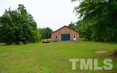 10394 Lake Royalle Road Spring Hope, NC 27882 - Photo 22 of 23 a front view of a house with a yard and trees