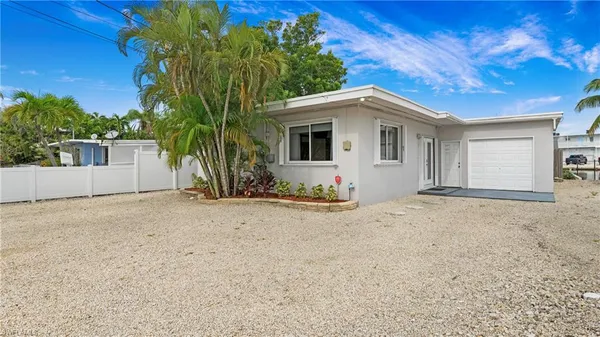 a view of a house with a yard and garage