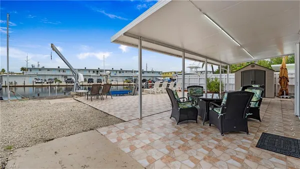 a view of a patio with table and chairs