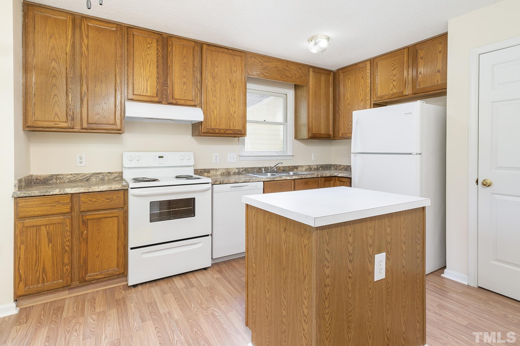 4105 Old Coach Road Raleigh, NC 27616 - Photo 5 of 22 a kitchen with a white cabinets and white appliances