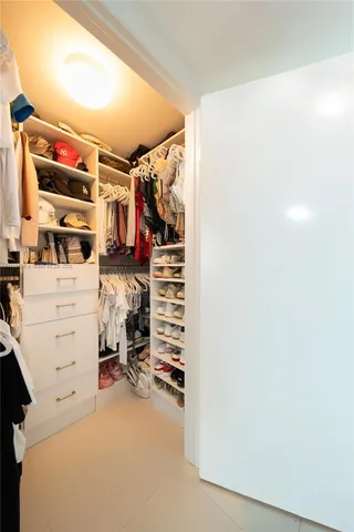 a view of walk in closet with clothes