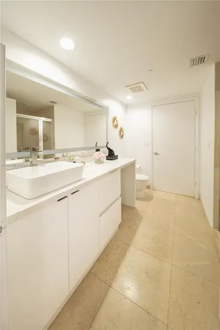 a room with a sink and cabinets