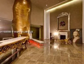 a living room with furniture a fireplace and potted plant