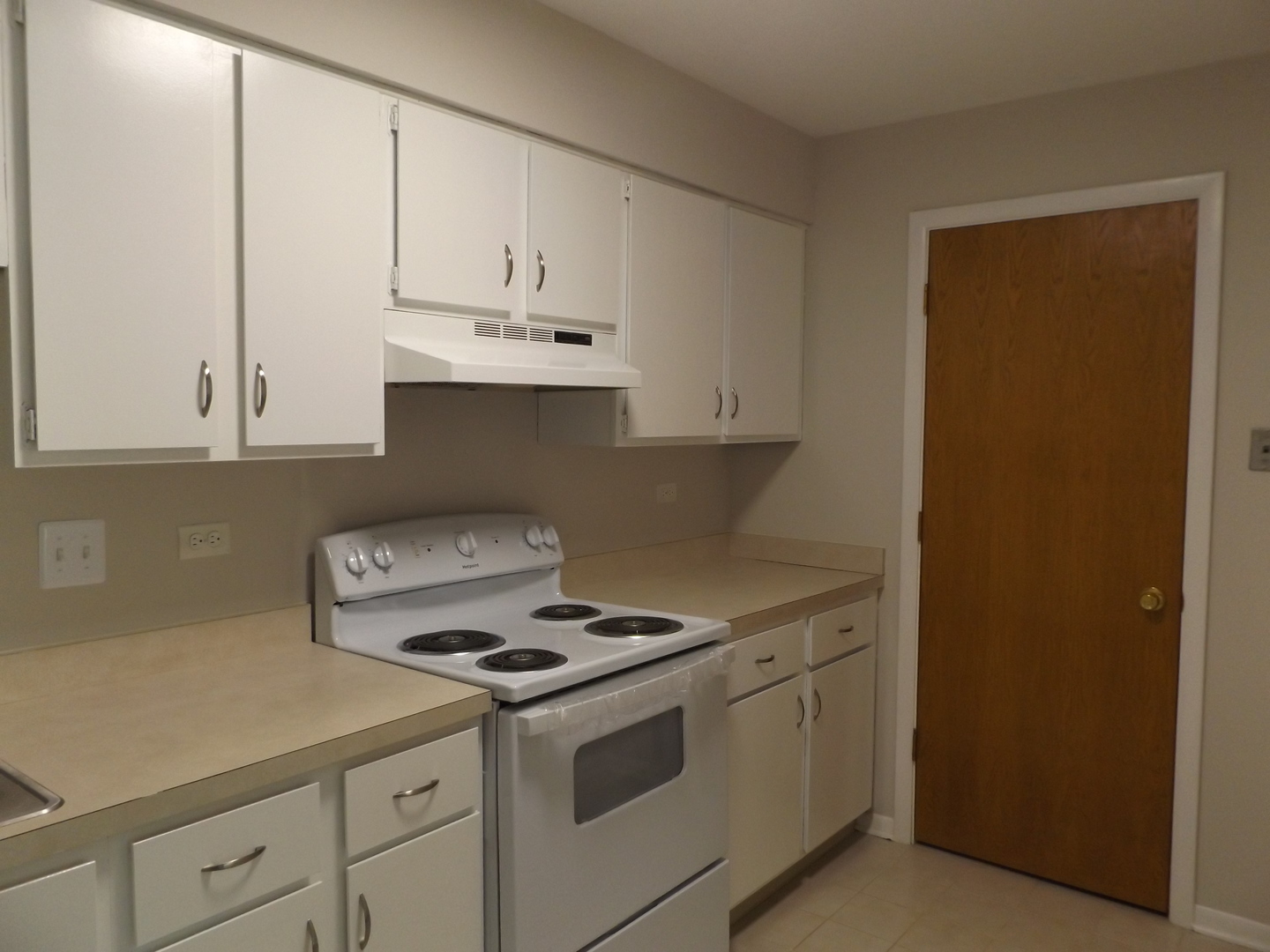 613 West Central Road, Unit C1 Mount Prospect, IL 60056 - Photo 7 of 14 a kitchen with granite countertop white cabinets and white appliances