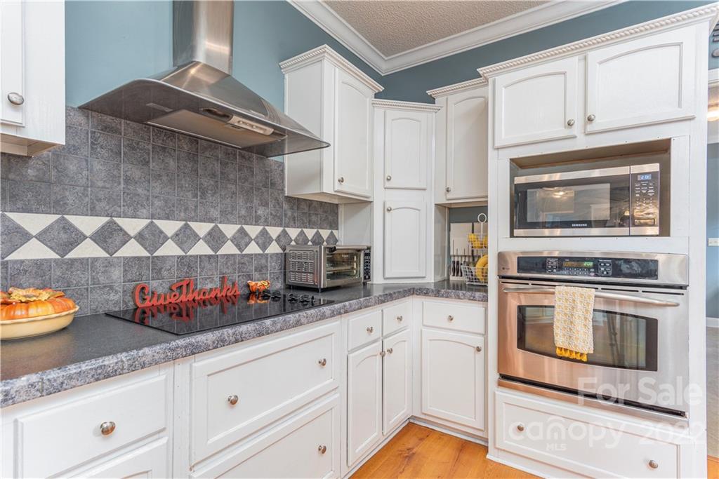 150 Triple R Drive Canton, NC 28716 - Photo 13 of 44 a kitchen with stainless steel appliances granite countertop white cabinets and a stove