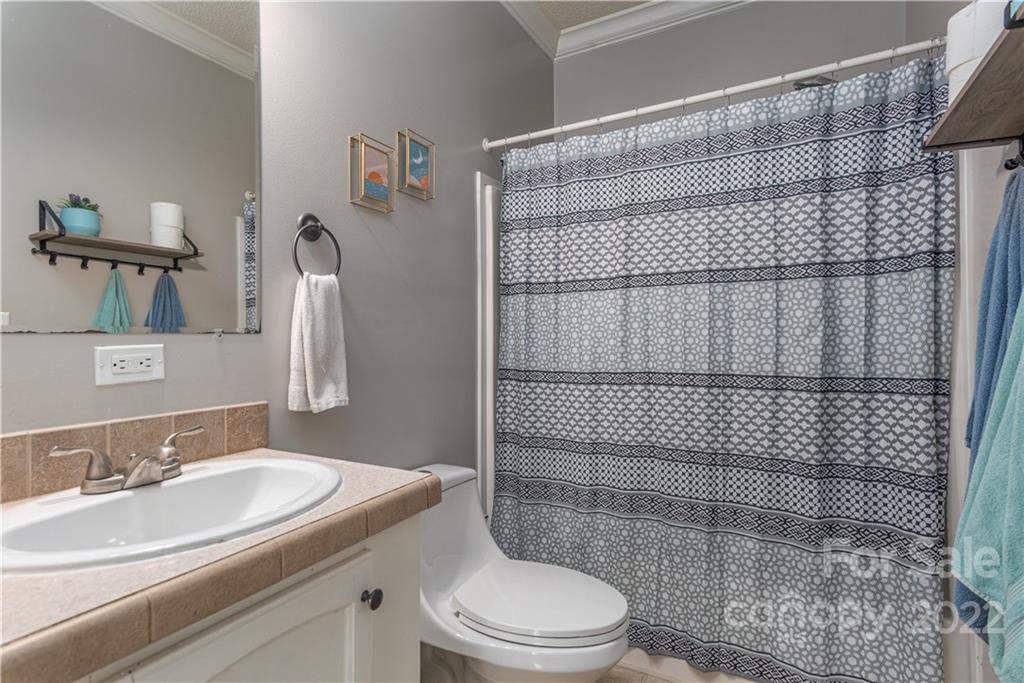 150 Triple R Drive Canton, NC 28716 - Photo 21 of 44 a bathroom with a sink a toilet and shower