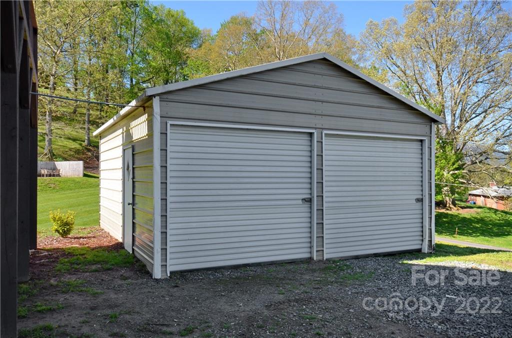 150 Triple R Drive Canton, NC 28716 - Photo 41 of 44 a wooden house with a yard and large trees