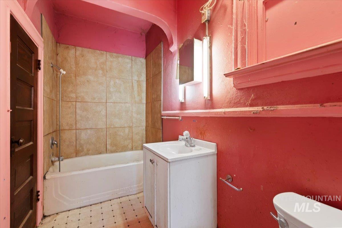 2114 North 9th Street Boise, ID 83702 - Photo 12 of 22 Bathroom featuring light flooring, vanity, and bathing tub / shower combination