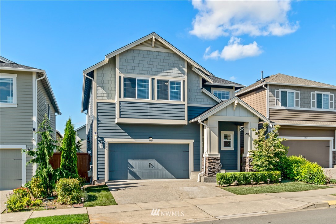 3917 174th Place Southeast Bothell, WA 98012 - Photo 2 of 31 a front view of a house with a yard