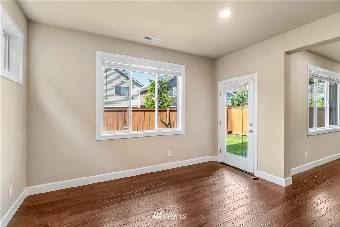 3917 174th Place Southeast Bothell, WA 98012 - Photo 13 of 31 an empty room with wooden floor and windows