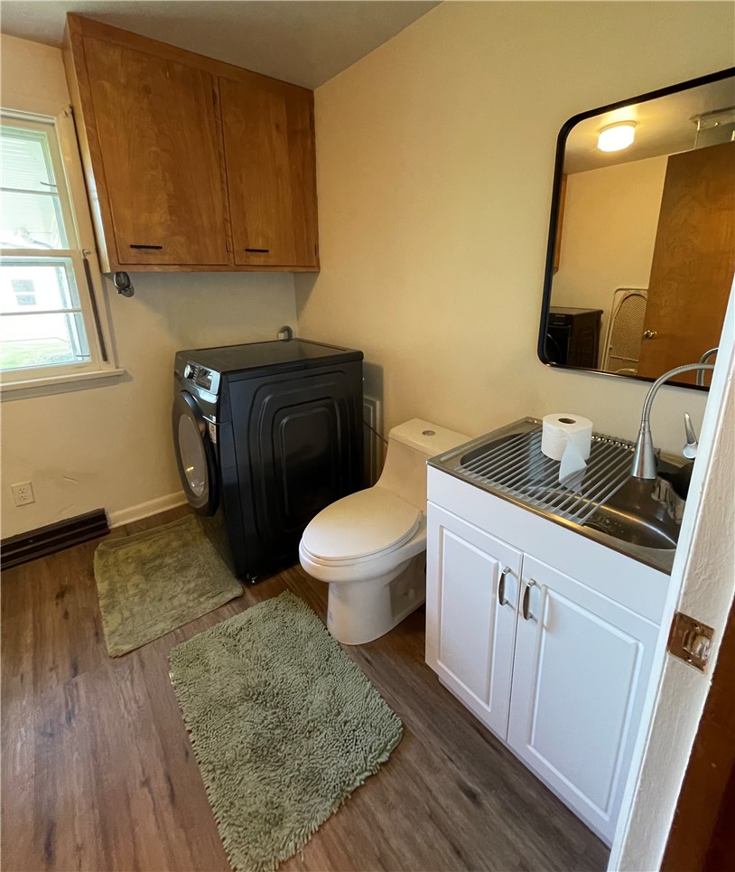 360 Ridge Street Piqua, OH 45356 - Photo 15 of 46 This functional space includes a laundry area and a convenient half bath, featuring a practical sink.