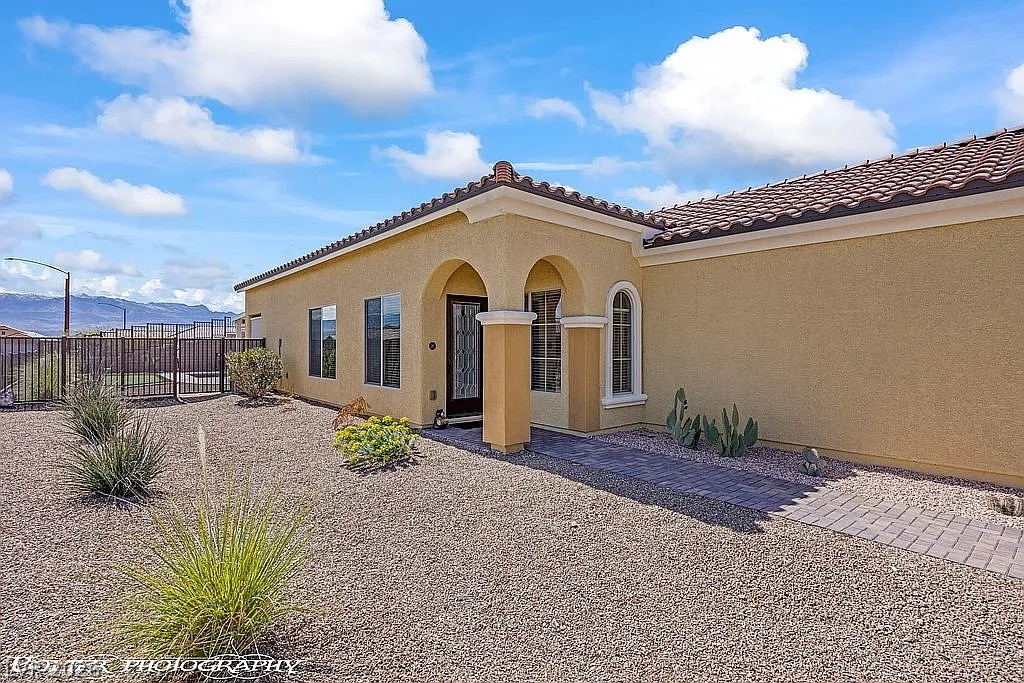 1304 Cottage Ridge Mesquite, NV 89034 - Photo 39 of 52 A terracotta-tiled roof crowns this stucco desert oasis, complete with an inviting arched entryway.