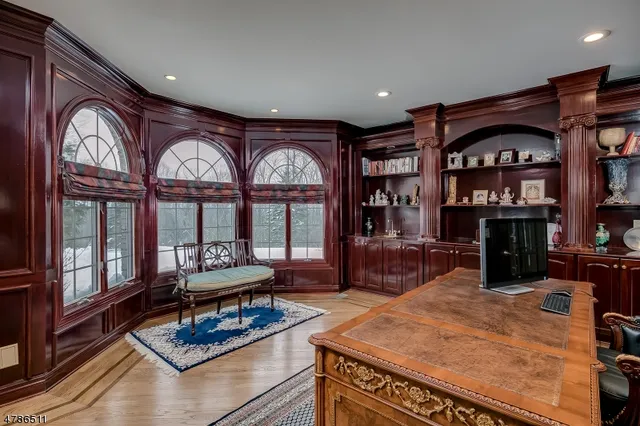a living room with furniture a large window and bookshelf