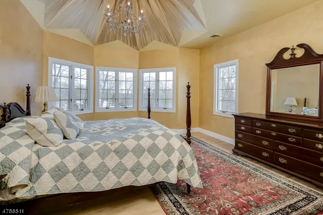 a bedroom with a bed next to a large window