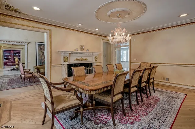 a view of a dining room with furniture and chandelier