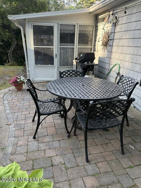 39 Hibiscus Place, Unit A Jackson, NJ 08527 - Photo 38 of 39 a view of a dinning table and chairs in patio of the house